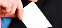 Man putting business card in his suit pocket