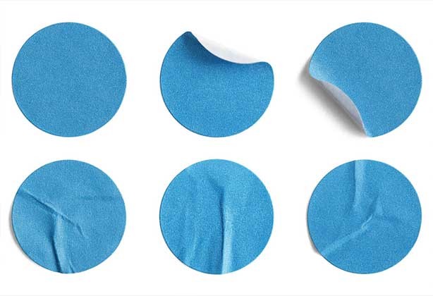 Blue circular stickers half-peeled off